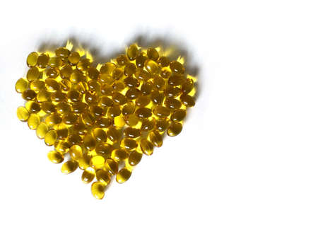 Yellow vitamins in the shape of a heartの写真素材