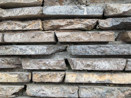 The surface of a stone wall. Masonry walls of old stone blocks. Background texture of a stone wall.の写真素材