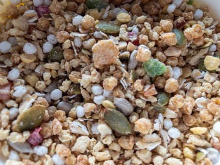 Useful flakes are scattered on the table. Muesli is a healthy Breakfast.の写真素材