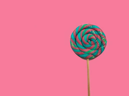 A large colored Lollipop isolated on a pinkの写真素材