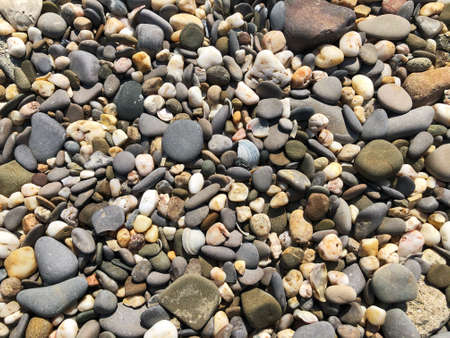Pebbles on the beach. Abstract background with round pebbles stones. Abstract background with round peeble stonesの写真素材