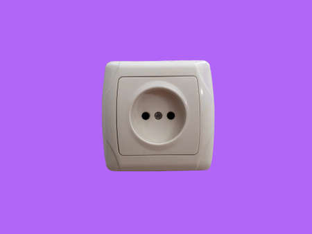 Electrical outlet isolated on a purple background. The socket on the wallの写真素材