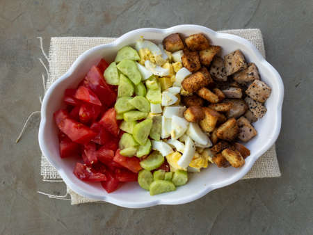 Tuna salad with crackers, tomatoes, cucumbers, boiled eggsの写真素材