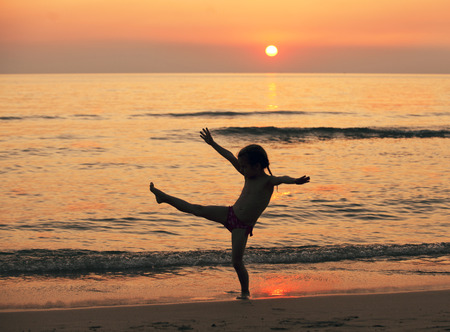 the silhouette of a little girl on the seaの写真素材