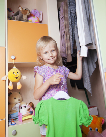 little girl chooses clothesの写真素材