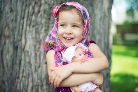 Girl hugging her doll  Portraitの写真素材