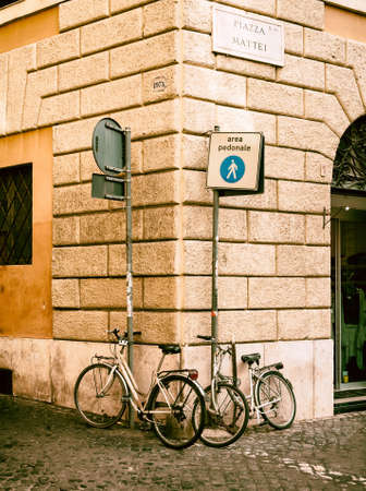 Two bicycles parked on the street in Rome, Italyの写真素材