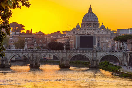 Sunset view of Basilica St Peter, bridge Sant Angelo and river Tiber in Rome. Italyの写真素材
