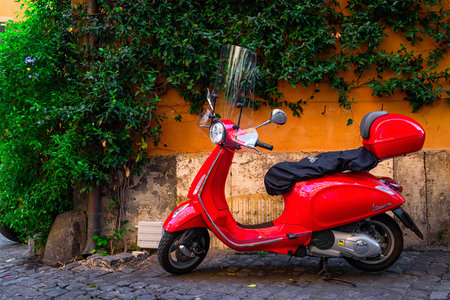 Rome, Italy - September 23, 2016: Red Vespa scooter parked on old street in Rome, Italyのeditorial素材