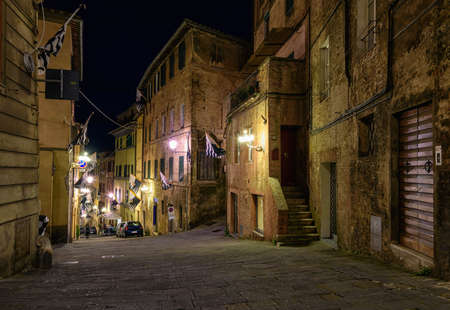 Medieval narrow cozy street in Siena, Tuscany, Italyの写真素材