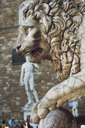 Statue of lion at Loggia Dei Lanzi in front of Florence Palazzo Vecchio and statue of David in Florence. Italyの写真素材