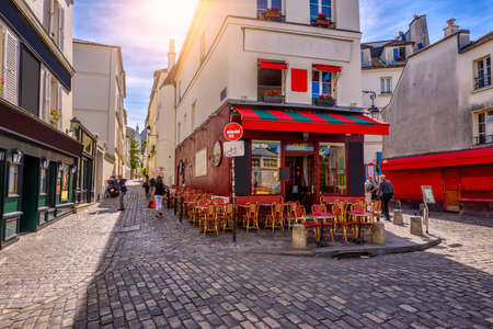 Cozy street with tables of cafe in quarter Montmartre in Paris, Franceの写真素材