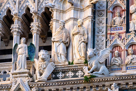 Sculptures on the facade of Siena Cathedral Santa Maria Assunta (Duomo di Siena) in Siena, Tuscanyの写真素材