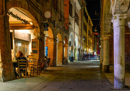 Cozy narrow street in Ferrara at night, Emilia-Romagna, Italy. Ferrara is the capital of the province of Ferraraの写真素材