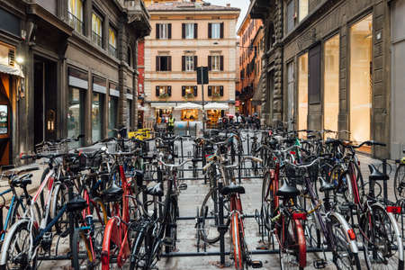 Old narrow street with parking of bicycles in Bologna, Emilia Romagna, Italyの写真素材