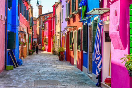 Street with colorful buildings in Burano island, Venice, Italy. Architecture and landmarks of Venice, Venice postcardの写真素材