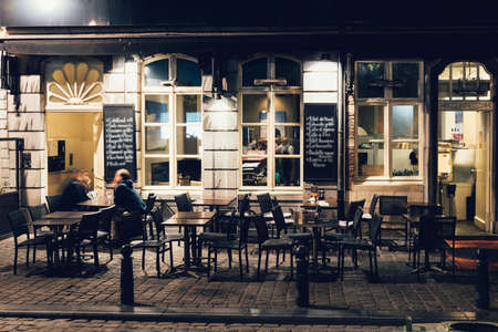 Old street with tables of cafe in center of Brussels, Belgium. Night cityscape of Brussels (Bruxelles). Architecture and landmarks of Brussels.の写真素材