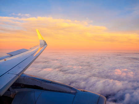 Morning sunrise with Wing of an airplaneの写真素材