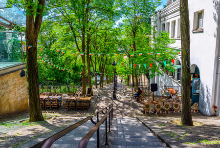 Cozy street with tables of cafe in quarter Montmartre in Paris, Franceの写真素材