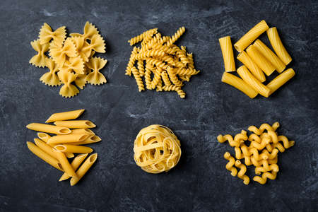 Various types of pasta. Pasta on black background.の写真素材
