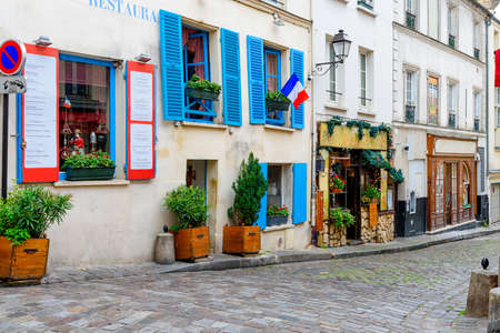 Cozy street in quarter Montmartre in Paris, France. Architecture and landmarks of Paris. Postcard of Parisの写真素材