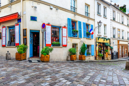 Cozy street with tables of cafe in quarter Montmartre in Paris, Franceの写真素材