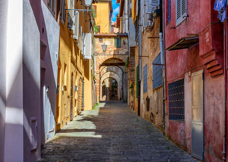Medieval narrow street in Siena, Tuscany, Italy. Architecture and landmark of Siena. Cozy cityscape of Sienaの写真素材