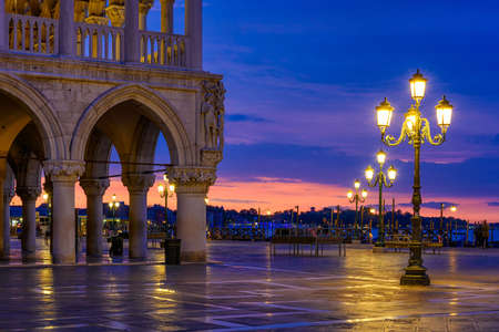 View of piazza San Marco, Doge's Palace (Palazzo Ducale) in Venice, Italy. Architecture and landmark of Venice. Night cityscape of Venice.の写真素材