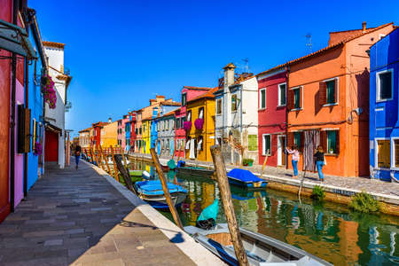 Street with colorful buildings and canal in Burano island, Venice, Italy. Architecture and landmarks of Venice, Venice postcardの写真素材
