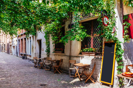 Old street with table of cafe in historic city center of Antwerpen (Antwerp), Belgium. Cozy cityscape of Antwerp. Architecture and landmark of Antwerpenの写真素材