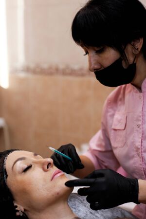 Russia, Novosibirsk, January 5, 2020. Woman lies with her eyes closed during the procedure in the...