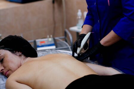 Russia, Novosibirsk, January 5, 2020. Woman lies with her eyes closed during the procedure in the...