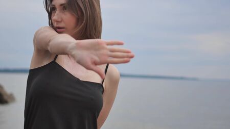 Young beautiful woman dancing on the seashoreの写真素材