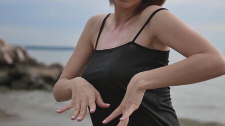 Young beautiful woman dancing on the seashoreの写真素材