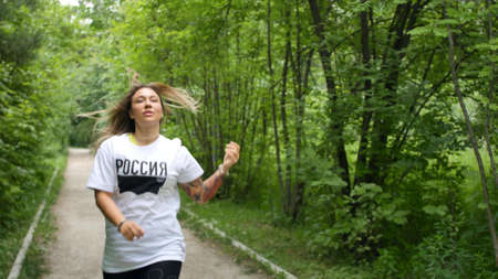 Russia, Novosibirsk, September 14, 2020. The athlete trains outdoors. Gymnastics in the morning in the park. Fitness, workout, sports conceptのeditorial素材