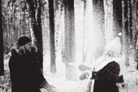 A loving couple walks in a winter park. Lovely happy lovers enjoying time together. Winter holidays concept.の写真素材