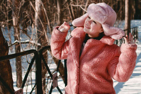 Portrait of a young woman in a winter fur hat outdoors. Winter Holidays Conceptの写真素材