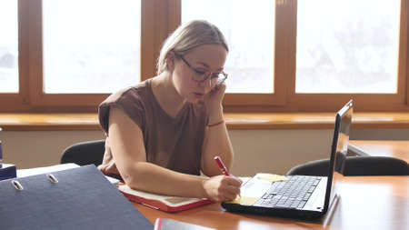 Attractive blonde works in the office