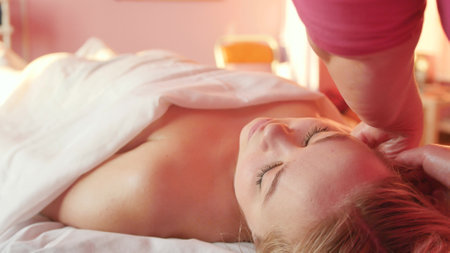 Young woman enjoying body massage in spa salon.の写真素材