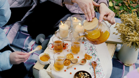young mother and daughter on a picnic in nature eat fresh honey. close-upの写真素材