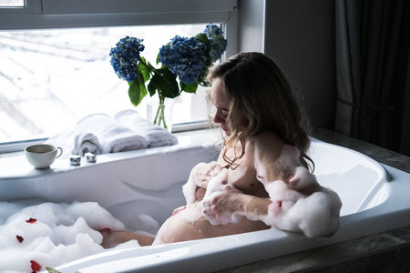 Pregnant woman taking a bath