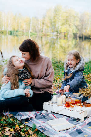 young mother and daughter on a picnic in nature eat fresh honey. close-upの写真素材
