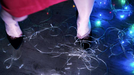 Legs of a dancing woman at a New Years party.