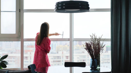 Attractive woman doing housework, washing big okgas at home. Housekeeping concept.