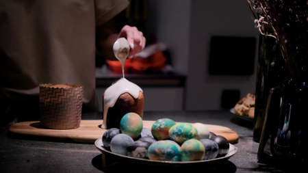 Cooking a traditional Easter cake. A woman decorates holiday pastries. Close-up.の写真素材