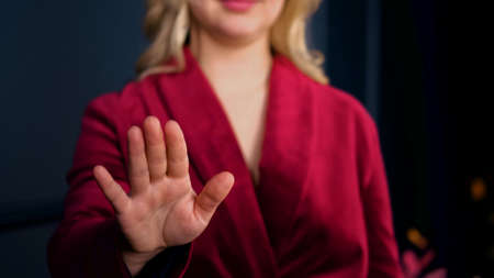 Hand point of a woman in a red suitの写真素材