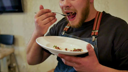 Close-up of a plate with a juicy dish of beef tartare. Tasting a delicious meal prepared by the chef