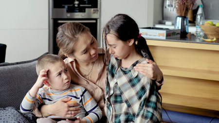 Caring young mother, talking to children, comforting sad children, help solve problem, provide psychological support in trust, honest conversationの写真素材