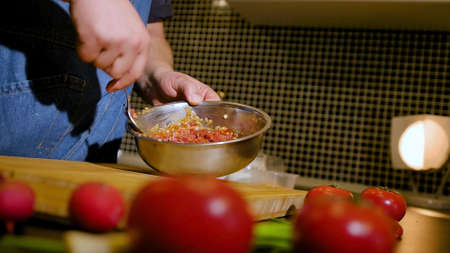 Close-up of a plate with a succulent dish of beef tartare. The chef prepares marinade for tartareの写真素材