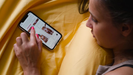 Buying underwear. Closeup shopping young woman chooses underwear in online store. Online shopping concept. Russia, Novosibirsk, August 17, 2022のeditorial素材